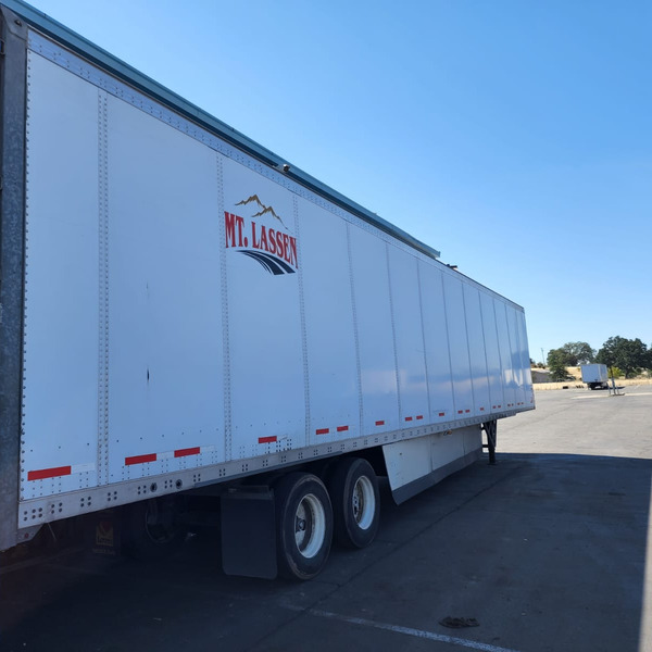 A fleet of white semi-trucks parked in a row